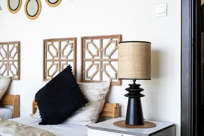 a lamp sitting on a table next to a bed at Marina Majesty- Homely & Cozy 2BR, CanalView, Central Location in Dubai