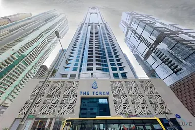 a yellow bus parked in front of a tall building at Marina Majesty- Homely & Cozy 2BR, CanalView, Central Location in Dubai