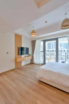 a bedroom with a large bed and a television at Modern Studio I Boulevard View I Downtown Dubai in Dubai