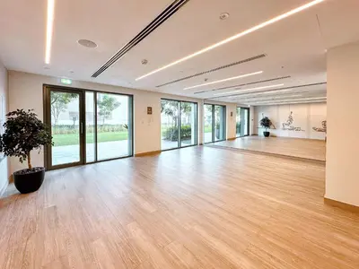 a large empty room with a potted plant in the middle at Amazing 1 Bedroom in Burj Royale Downtown in Dubai