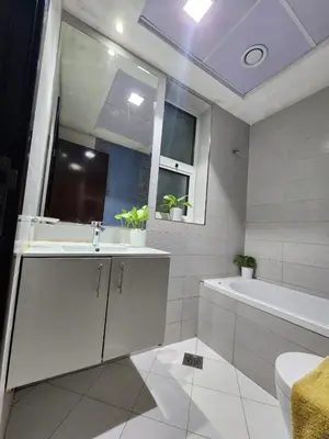 a bathroom with a sink and a tub and a toilet at Dubai Silicon Oasis Staycation in Dubai