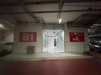 a room with a glass door in a parking garage at Dubai Silicon Oasis Staycation in Dubai