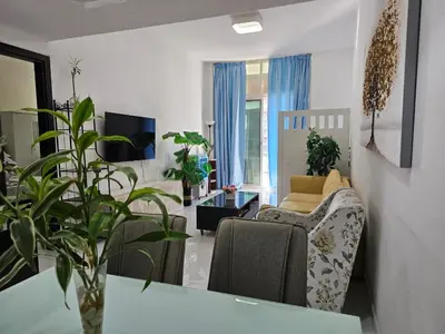 a living room with a couch and a chair at Dubai Silicon Oasis Staycation in Dubai