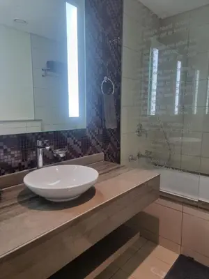 a bathroom with a white bowl sink on a counter at 1 Bedroom Tower D Paramount Apt in Dubai