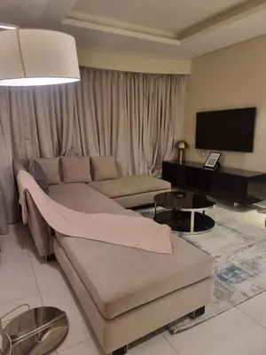 a living room with a couch and a flat screen tv at 1 Bedroom Tower D Paramount Apt in Dubai