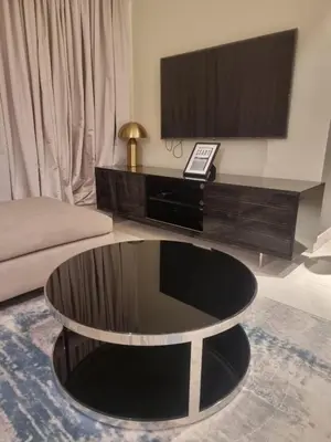 a living room with a coffee table and a tv at 1 Bedroom Tower D Paramount Apt in Dubai