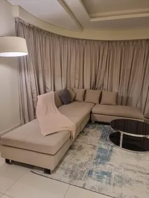 a living room with a couch and a table at 1 Bedroom Tower D Paramount Apt in Dubai