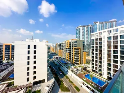 an aerial view of a city with tall buildings at Cozy Studio in Azizi Riviera with Balcony in Meydan City in Dubai
