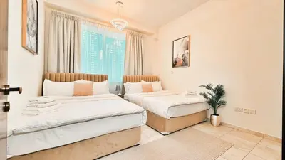 a bedroom with two beds and a window at Stylish Marina View Apartment With Private Marina Walk Access in Dubai