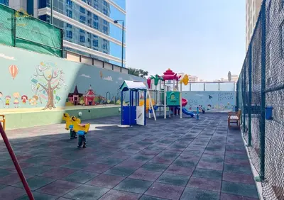 a playground in a building with a mural on the wall at Modern Studio at The Crescent Tower B, IMPZ - In the heart of Dubai in Dubai