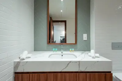 a bathroom with a sink and a mirror at Luxe 1BR in Citywalk with Pool Balcony & More in Dubai