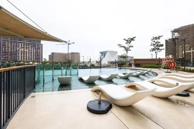 a row of white toilets sitting on top of a building at Luxe 1BR in Citywalk with Pool Balcony & More in Dubai
