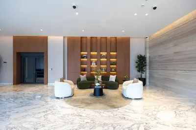 a lobby with couches and chairs in a building at Luxe 1BR in Citywalk with Pool Balcony & More in Dubai