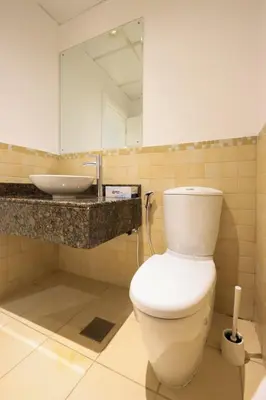 a bathroom with a white toilet and a sink at Cozy Dubai Eye & Sunset Views - JBR Beachfront - Gym & Pool - Free Parking in Dubai