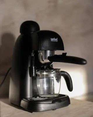 a coffee maker sitting on top of a table at Cozy Dubai Eye & Sunset Views - JBR Beachfront - Gym & Pool - Free Parking in Dubai