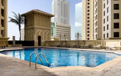 a swimming pool in the middle of a city with buildings at FIRST CLASS 2BR Breathtaking Beach Views in Dubai
