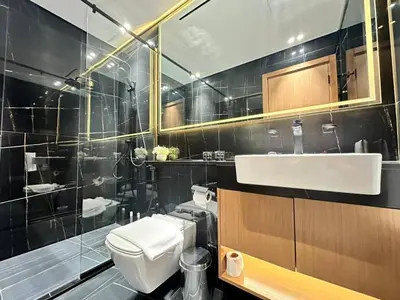 a bathroom with a white toilet and a sink at Bright 1br Jvc Balcony & Free Parking in Dubai