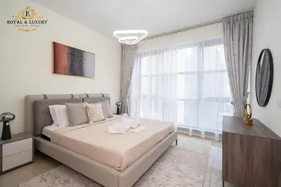 a bedroom with a bed and a large window at Chic 1-Bedroom Haven in Standpoint A Tower, Downtown Dubai in Dubai