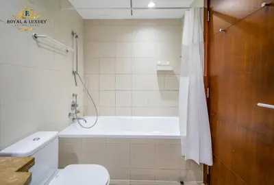 a bathroom with a bath tub and a toilet at Chic 1-Bedroom Haven in Standpoint A Tower, Downtown Dubai in Dubai