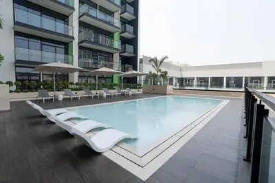 a swimming pool in the middle of a building at Comfortable 1br In Jvc Balcony Free Parking in Dubai
