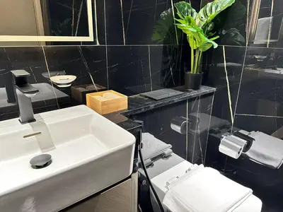 a bathroom with a white sink and a toilet at Modern 1br In Jvc Balcony, Pool & Parking in Dubai