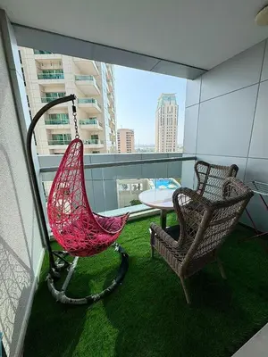 a balcony with a hammock and a table and chairs at Chic Studio in Dubai Marina in Dubai