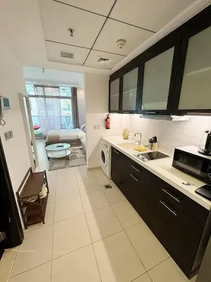 a kitchen with a sink and a stove top oven at Chic Studio in Dubai Marina in Dubai