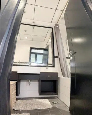a bathroom with a mirror and a sink at Chic Studio in Dubai Marina in Dubai