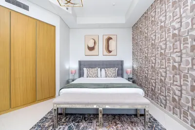 a bedroom with a king sized bed and a wall at Aykon City Tower I Birds Eye View in Dubai