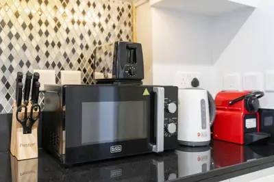 a microwave sitting on top of a kitchen counter at Aykon City Tower I Birds Eye View in Dubai