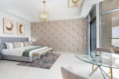a bedroom with a bed and a glass table at Aykon City Tower I Birds Eye View in Dubai