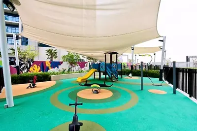 a playground with a slide and a swing at Aykon City Tower I Birds Eye View in Dubai