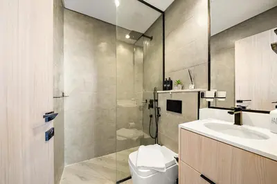 a bathroom with a toilet and a sink and a shower at Elegant 1 BR in Empire Residence in Dubai