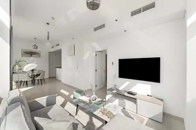 a living room with a couch and a flat screen tv at Silkhaus Comfy 1BR in Botanica Tower near Dubai Marina in Dubai