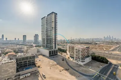 an aerial view of a city with a tall building at Cozy 1BR with Balcony in Binghatti House, Jumeirah Village Circle by Deluxe Holiday Homes in Dubai