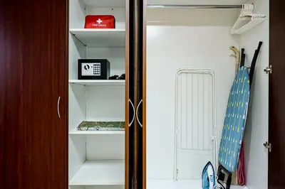 a closet with a door open with an umbrella at Modern Studio in Discovery Gardens, Close to Metro in Dubai