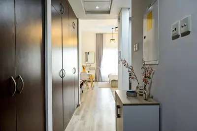 a hallway leading to a living room with a table at Modern Studio in Discovery Gardens, Close to Metro in Dubai