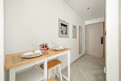 a kitchen with a table with plates on it at Cozy Studio in Empire Residence in Dubai
