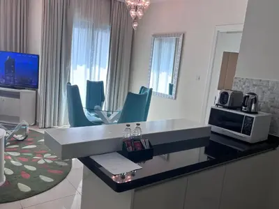 a kitchen with a sink and chairs in a room at Dubai mall area in Dubai