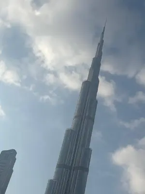 a view of the burj khalifa against a cloudy sky at Dubai mall area in Dubai
