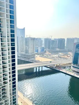 a bridge over a river in a city with buildings at Luxury Studio Near Burj Khalifa in Dubai