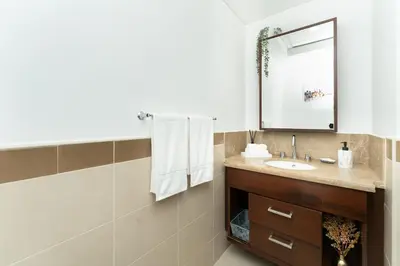 a bathroom with a sink and a mirror at King 1BR Apartment With Burj Khalifa & Fountain View in Dubai