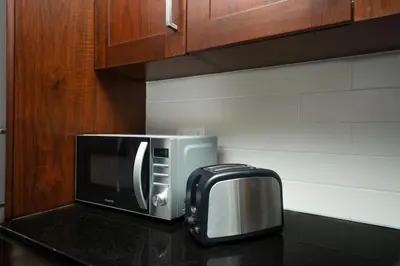 a microwave sitting on top of a kitchen counter at King 1BR Apartment With Burj Khalifa & Fountain View in Dubai