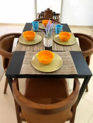 a table with plates and bowls on top of it at Cozy home marina in Dubai