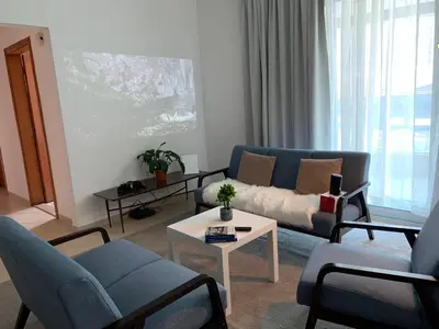 a living room with a couch and a table at Cozy home marina in Dubai