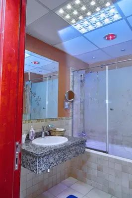 a bathroom with a sink and a shower at ROYAL BEACH RESiDENCES 1 in Dubai