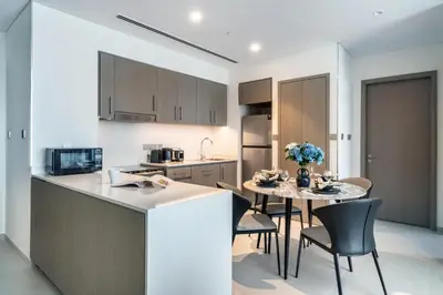 a kitchen and dining room with a table and chairs at The Smart Concierge - Signature Grande in Dubai