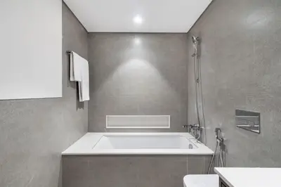 a bathroom with a bath tub and a shower at The Smart Concierge - Signature Grande in Dubai