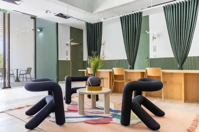 a room with black chairs and a table at Mood Living 22 in Dubai