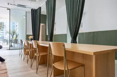 a long wooden table and chairs in a room at Mood Living 22 in Dubai
